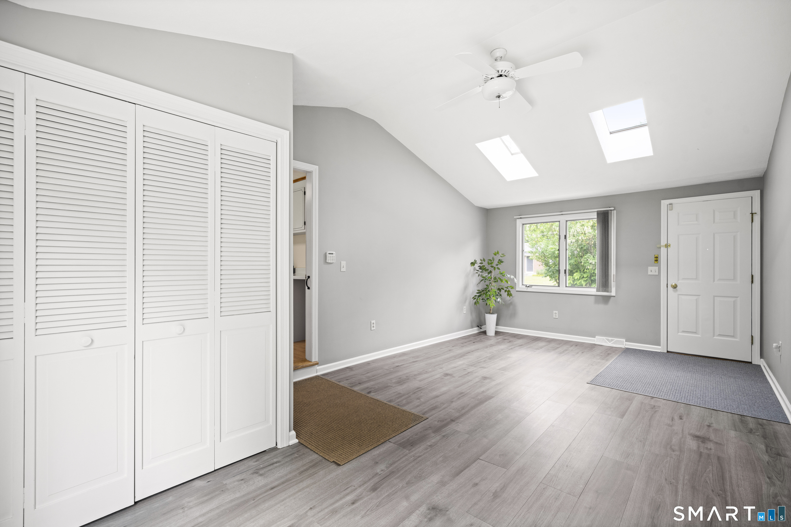 6 Cartier Road Enfield, CT 06082 - Photo 6 of 40 an empty room with wooden floor and windows
