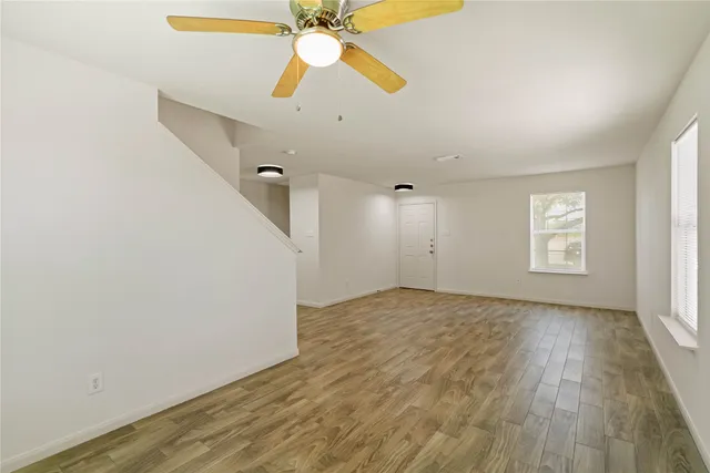 wooden floor in an empty room with a window