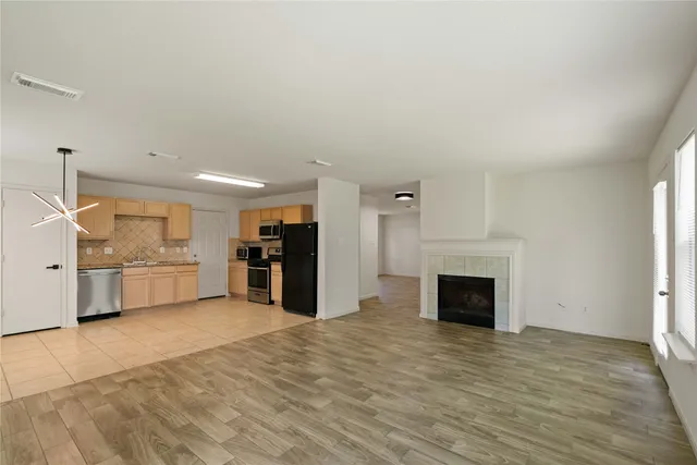 a view of a kitchen with a sink cabinets and a fireplace