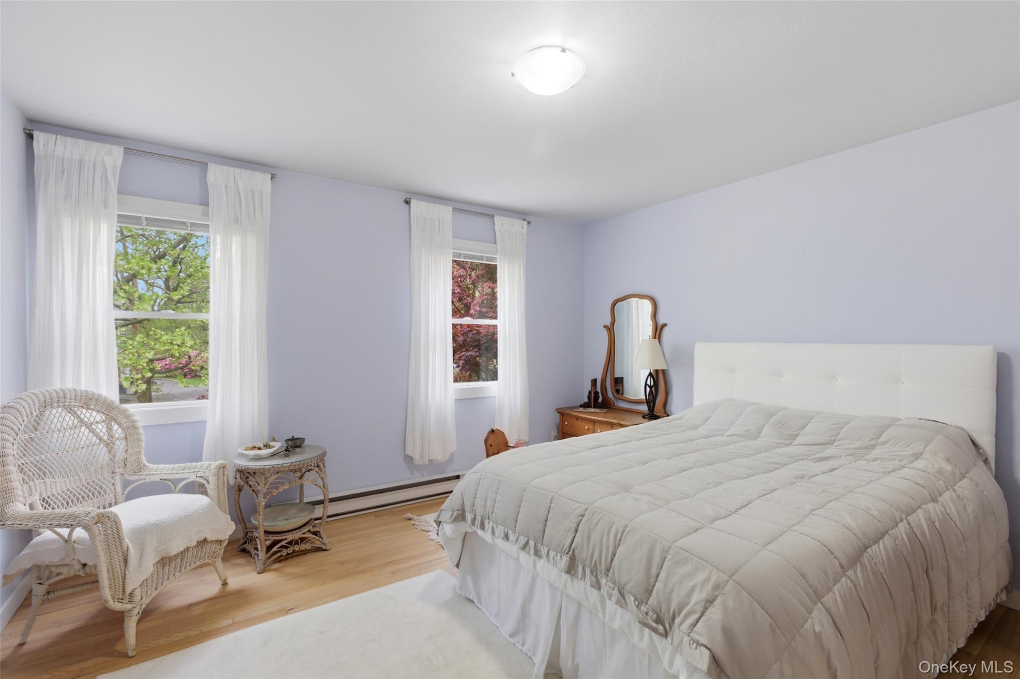 7 Gun Path Setauket, NY 11733 - Photo 23 of 34 a bedroom with a bed large window and couch
