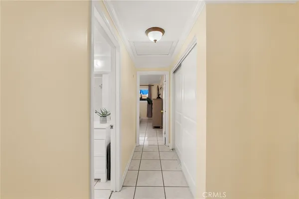 a view of a hallway with wooden shelves