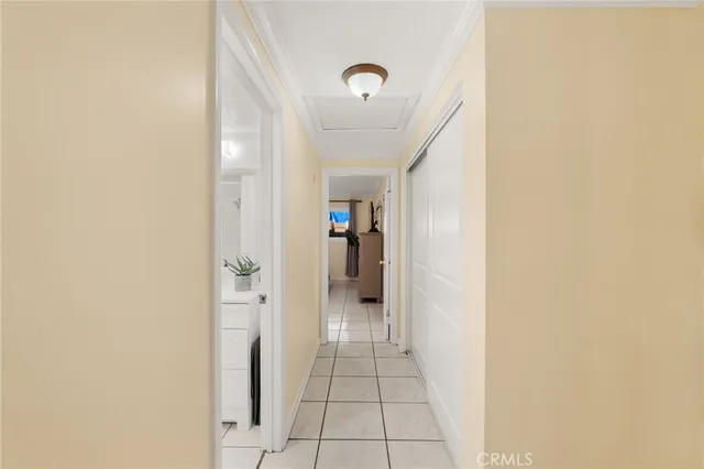 a view of a hallway with wooden shelves