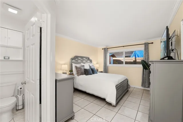 a bedroom with a bed and a view of bathroom