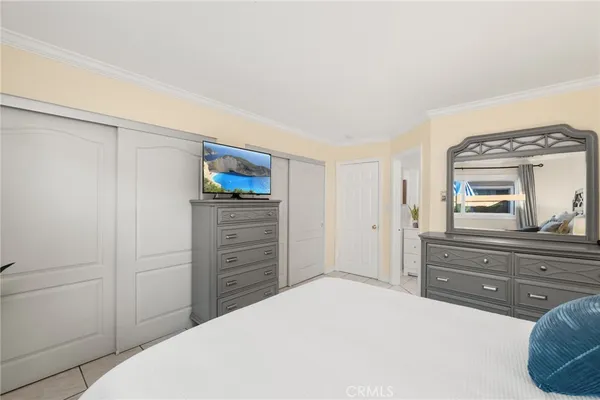 a bedroom with a bed and a dresser