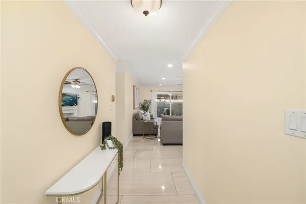 a view of a hallway with a livingroom and furniture