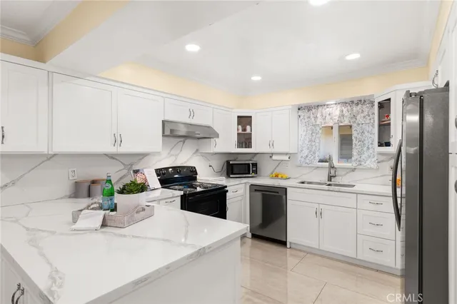 a kitchen with a sink a stove and refrigerator