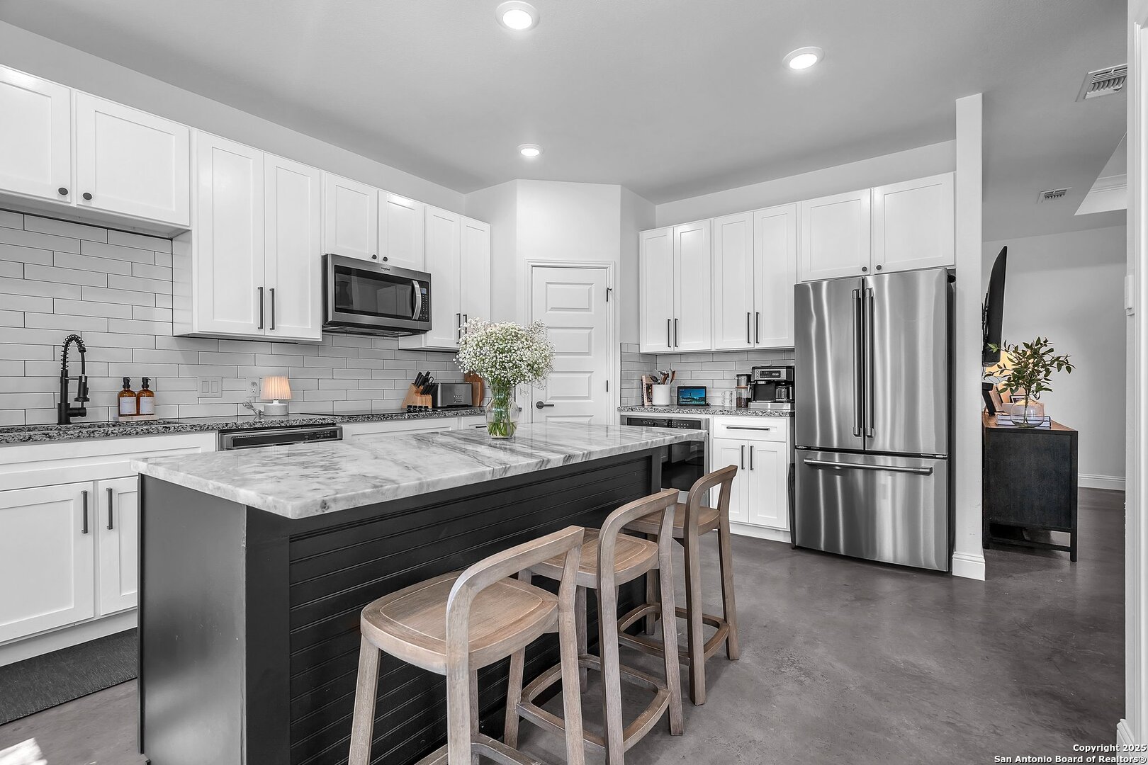 348 Fawn Drive Spring Branch, TX 78070 - Photo 16 of 48 a kitchen with kitchen island granite countertop a refrigerator stove microwave and sink