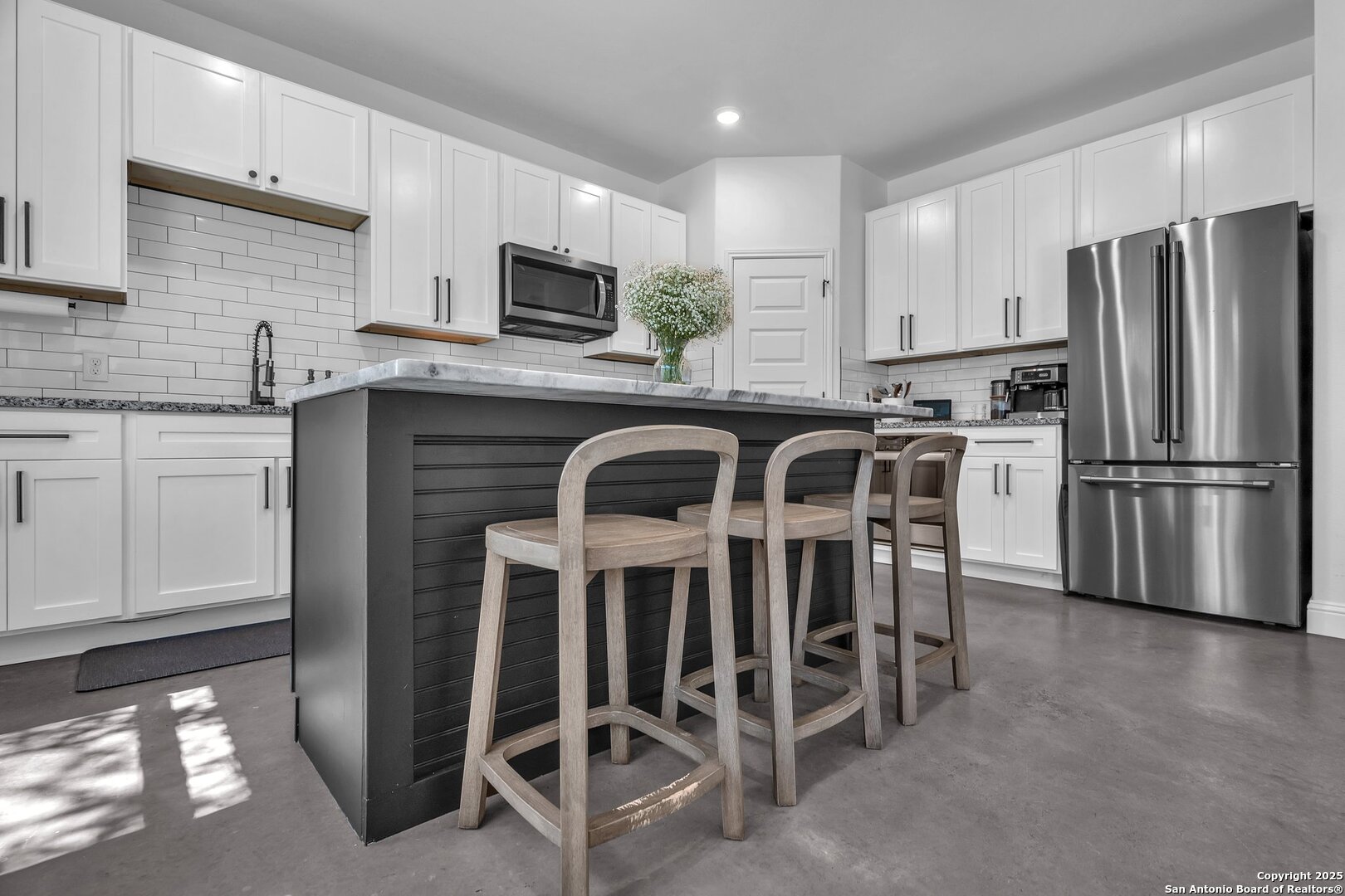 348 Fawn Drive Spring Branch, TX 78070 - Photo 17 of 48 a kitchen with stainless steel appliances a table chairs microwave and refrigerator