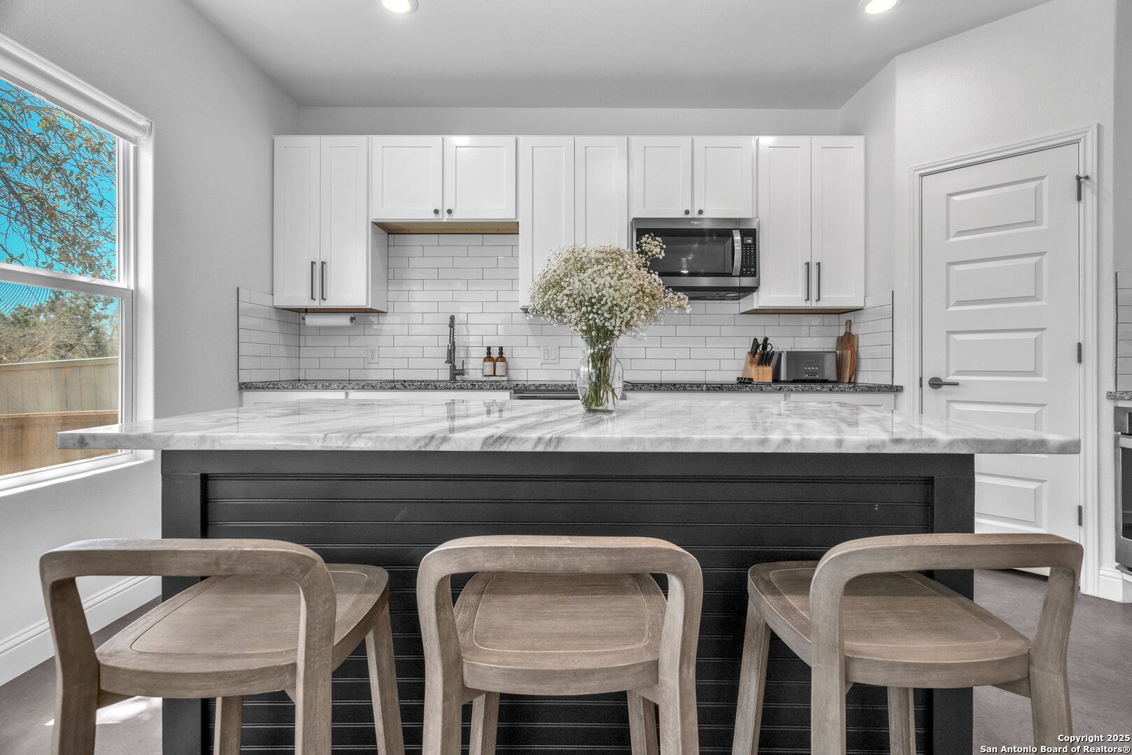 348 Fawn Drive Spring Branch, TX 78070 - Photo 24 of 48 a kitchen with granite countertop white cabinets and microwave