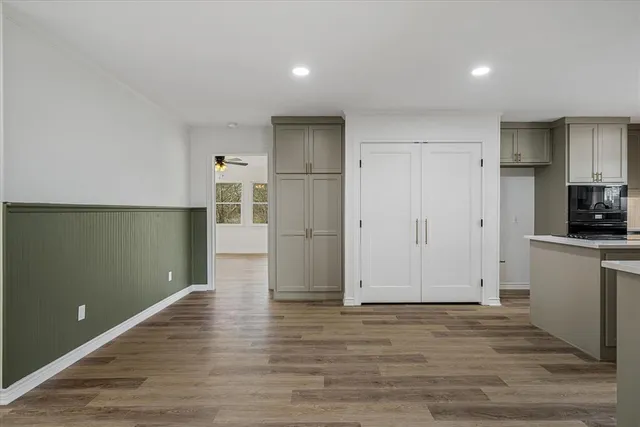 a view of a kitchen with a refrigerator cabinets and wooden floor