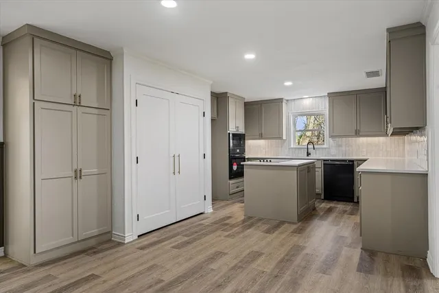 a kitchen with a refrigerator a sink and cabinets