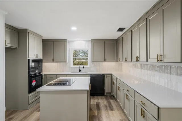 a kitchen that has a sink and a stove in it