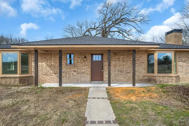 front view of a house with a large window