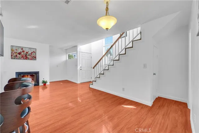 a view of room with stairs and wooden floor