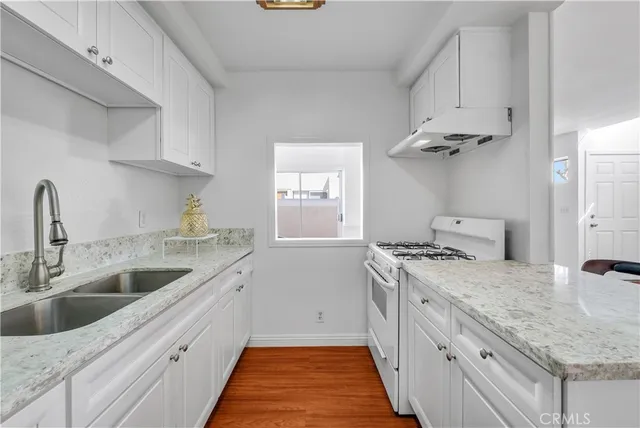 a kitchen with a sink stove and cabinets