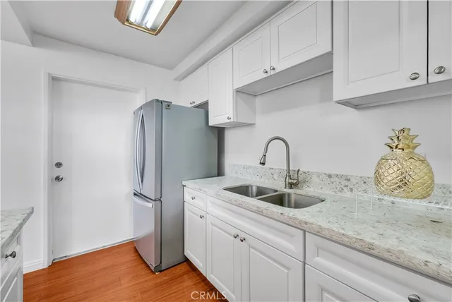 a kitchen with stainless steel appliances granite countertop a refrigerator and a sink