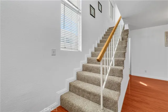 a view of entryway with wooden floor and stairs