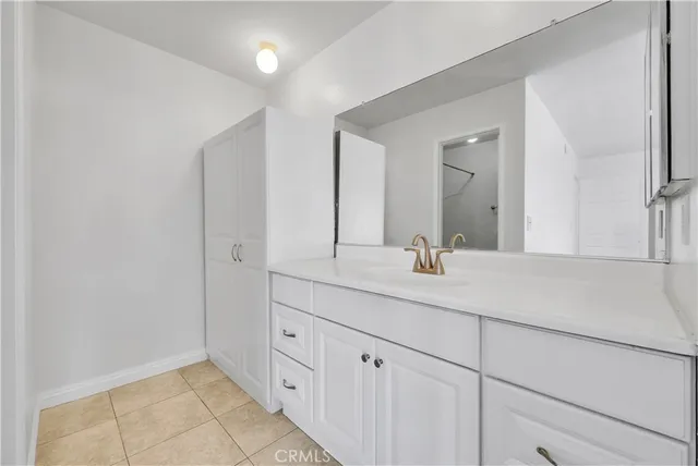 a bathroom with a double vanity sink and mirror