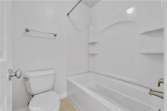 a bathroom with a toilet and a bathtub