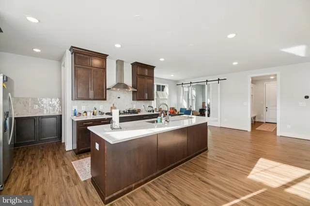 a kitchen with a stove a sink a refrigerator and cabinets