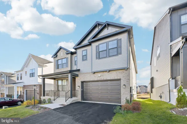 a view of a white house next to a yard