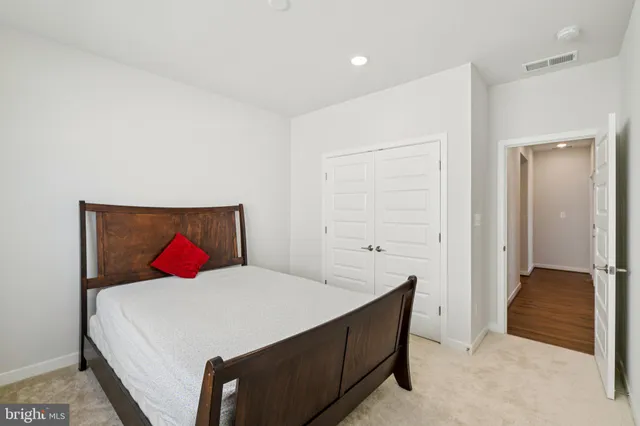 a view of a big room with wooden floor and windows