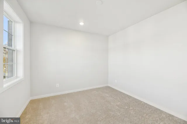 an empty room with furniture and a flat screen tv