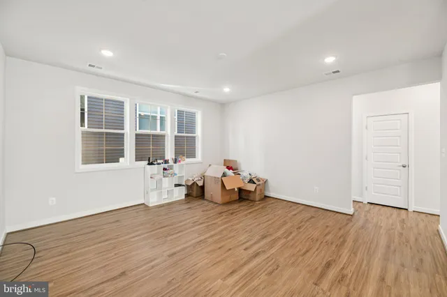 a view of a room with furniture and a table
