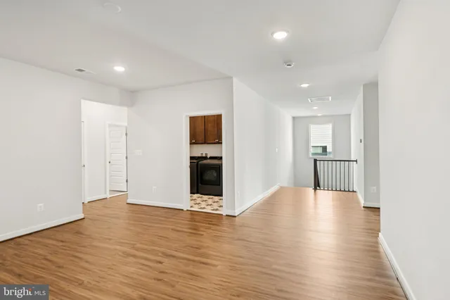 a view of a room with wooden floor