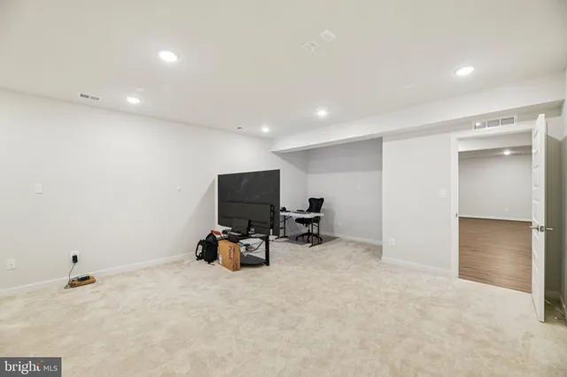 a bathroom with a sink a toilet a mirror and shower