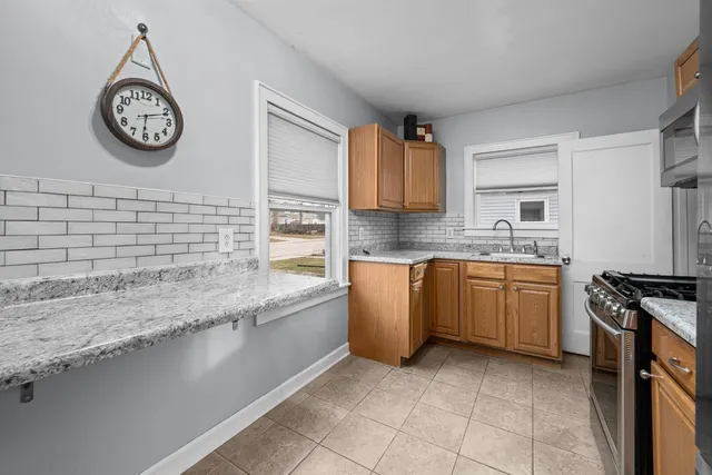 a kitchen with a sink cabinets and a stove top oven