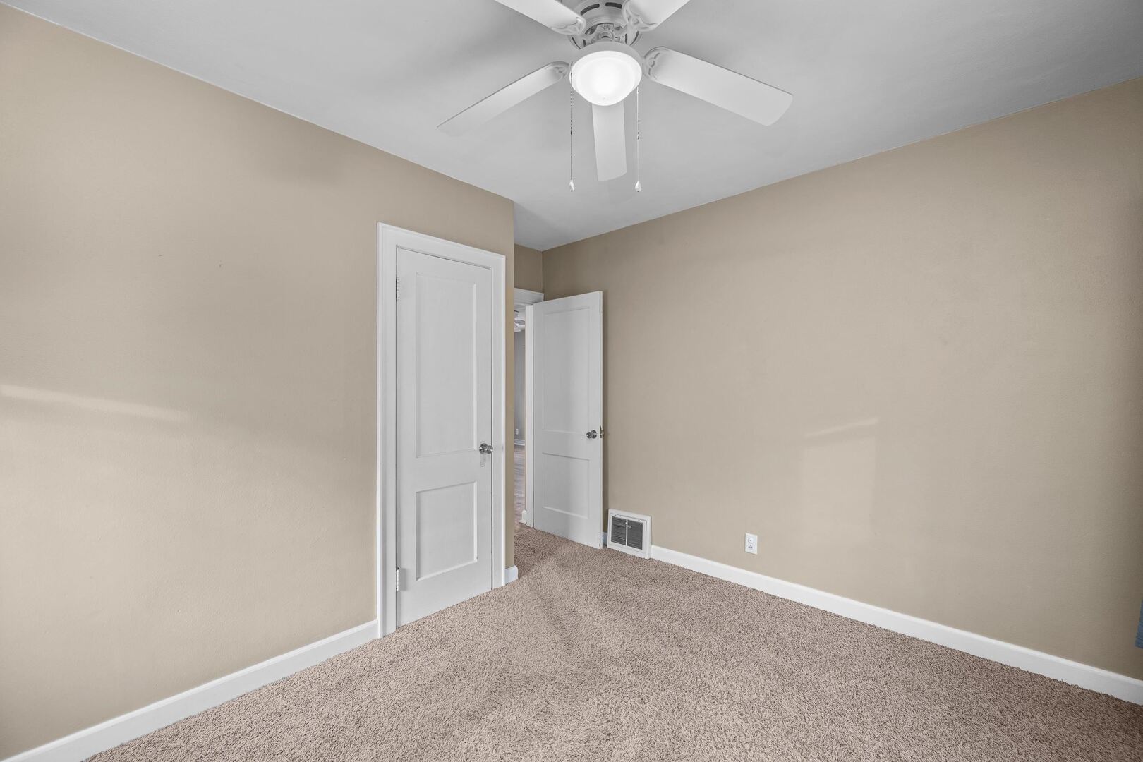 2517 3rd Street East Moline, IL 61244 - Photo 13 of 22 an empty room with a chandelier fan and a chandelier fan