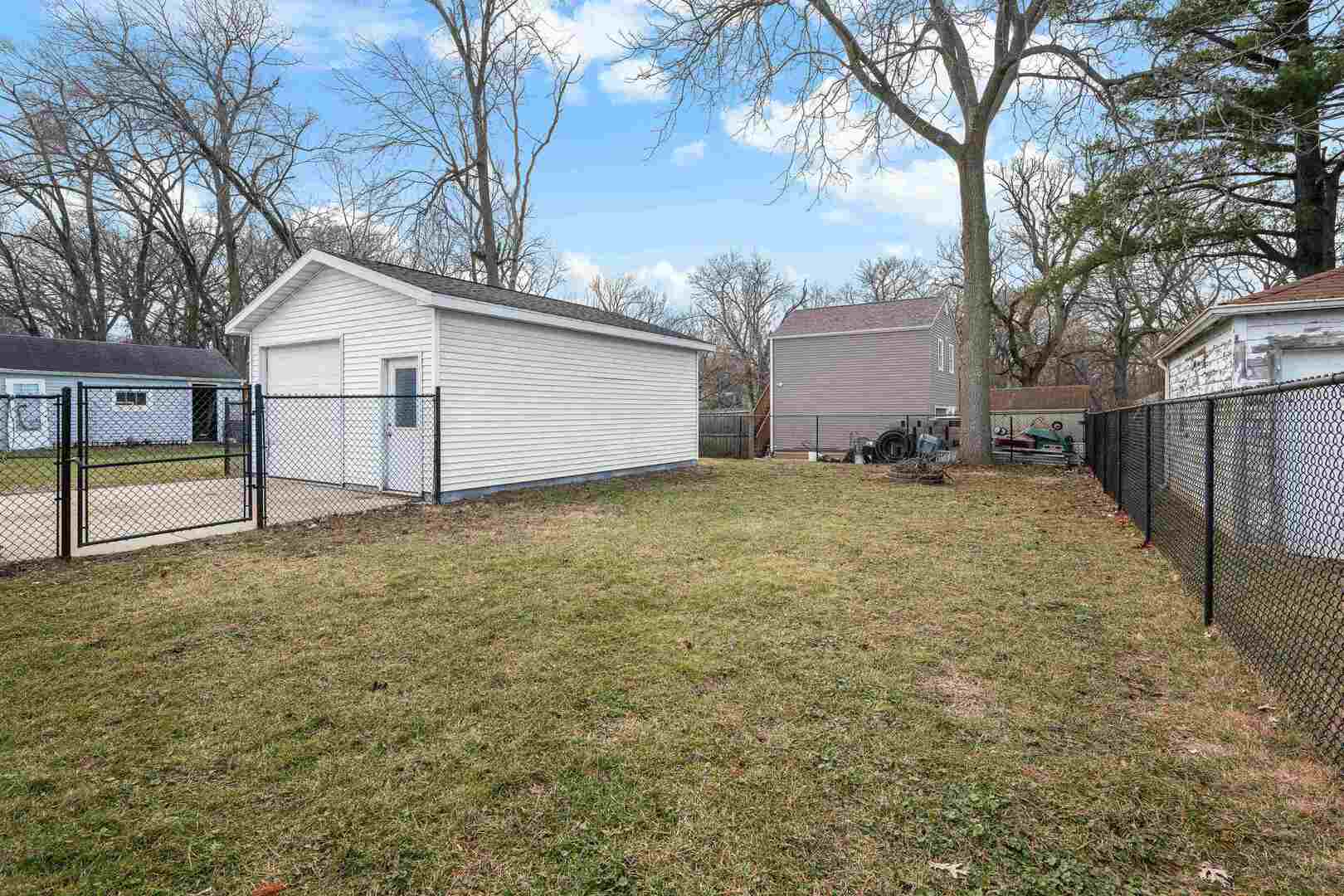 2517 3rd Street East Moline, IL 61244 - Photo 21 of 22 a view of a backyard with a large tree