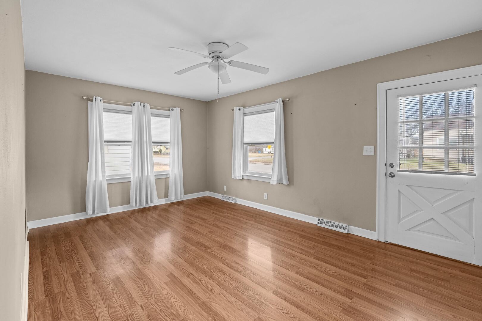 2517 3rd Street East Moline, IL 61244 - Photo 4 of 22 a view of an empty room with a window and wooden floor