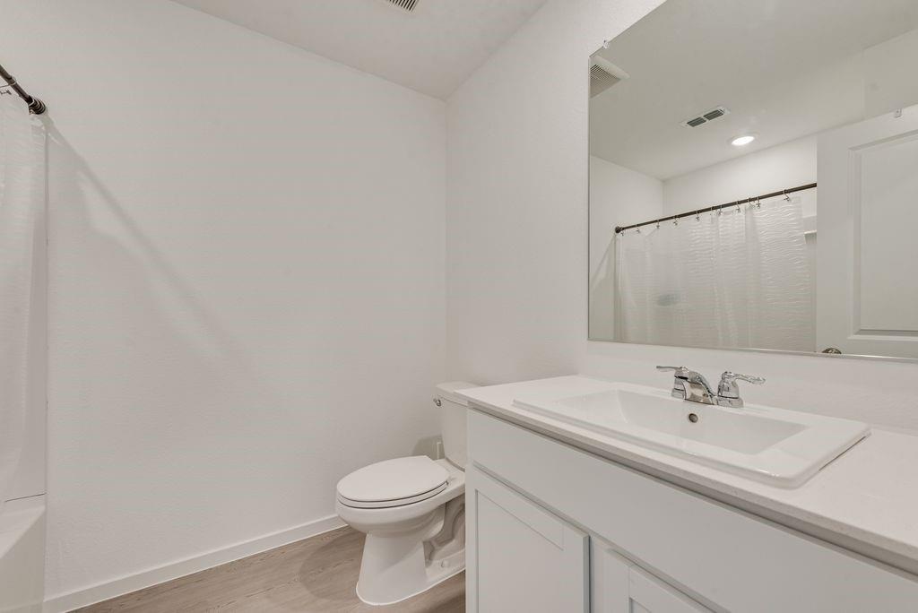 14112 Hammersmith Street Pilot Point, TX 76258 - Photo 12 of 19 a bathroom with a sink toilet and vanity