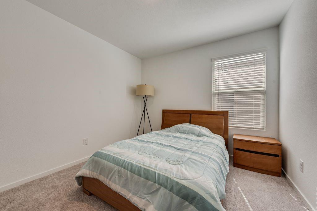 14112 Hammersmith Street Pilot Point, TX 76258 - Photo 13 of 19 a bed sitting in a bedroom next to a window