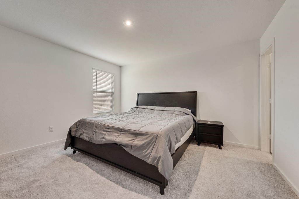 14112 Hammersmith Street Pilot Point, TX 76258 - Photo 15 of 19 a bedroom with a bed and window