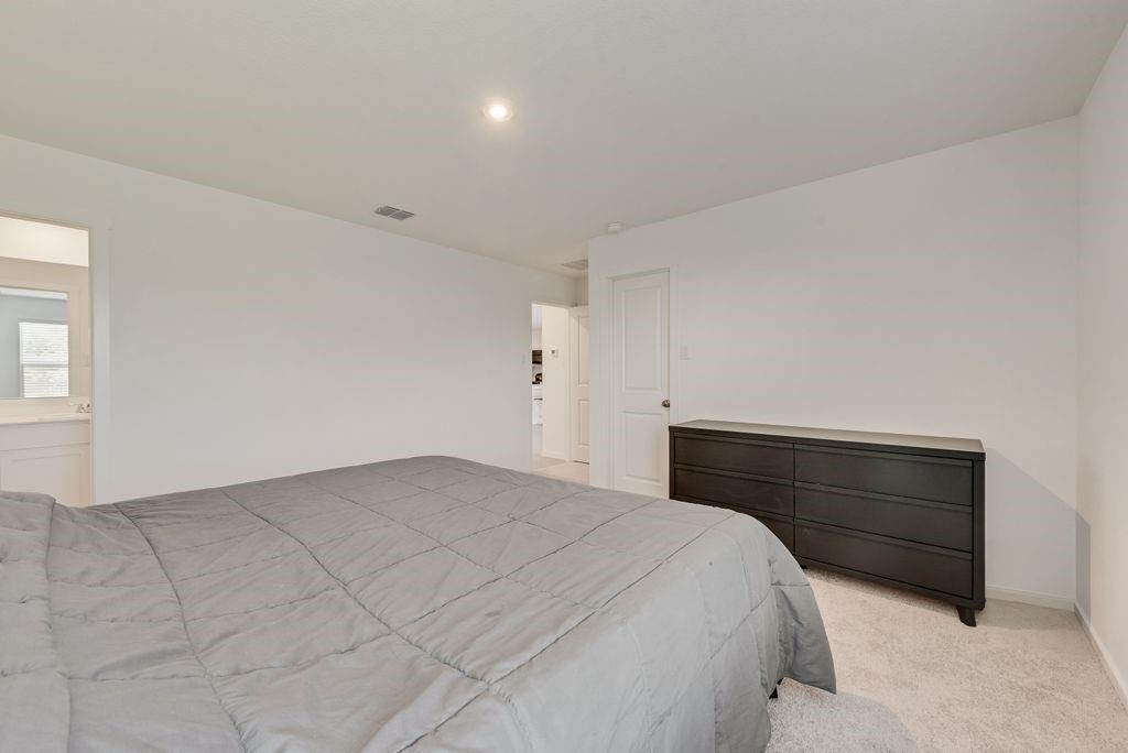 14112 Hammersmith Street Pilot Point, TX 76258 - Photo 16 of 19 a bedroom with a bed and window