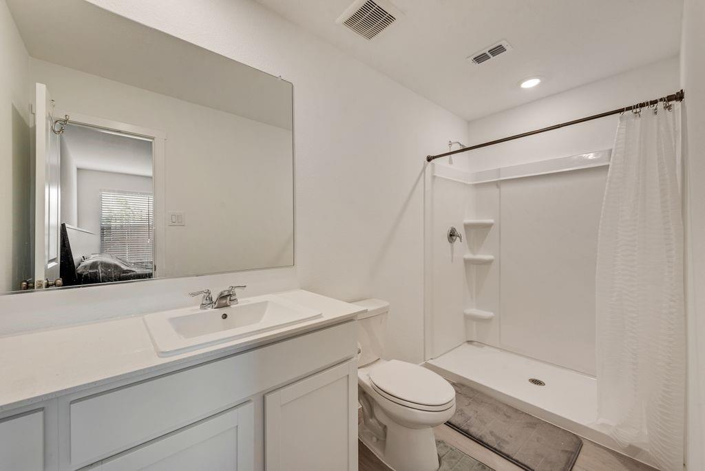 14112 Hammersmith Street Pilot Point, TX 76258 - Photo 17 of 19 a bathroom with a sink a toilet and shower