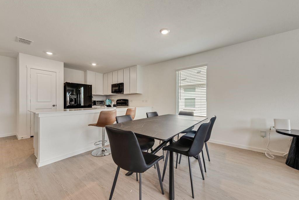 14112 Hammersmith Street Pilot Point, TX 76258 - Photo 8 of 19 a view of a dining room with furniture and wooden floor