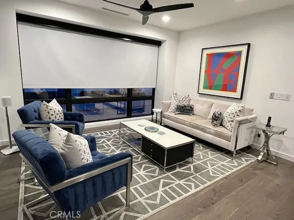 a bedroom with a bed and a flat tv screen on dresser