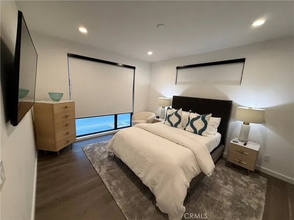 a bedroom with a bed and a flat screen tv