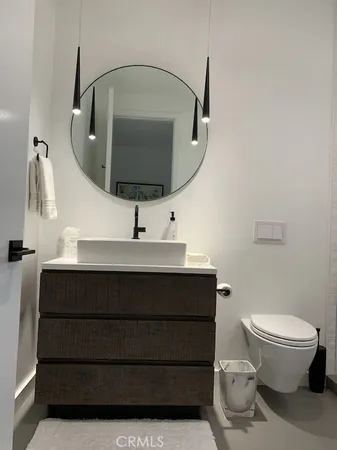 a spacious bathroom with a double vanity sink a large mirror and a shower