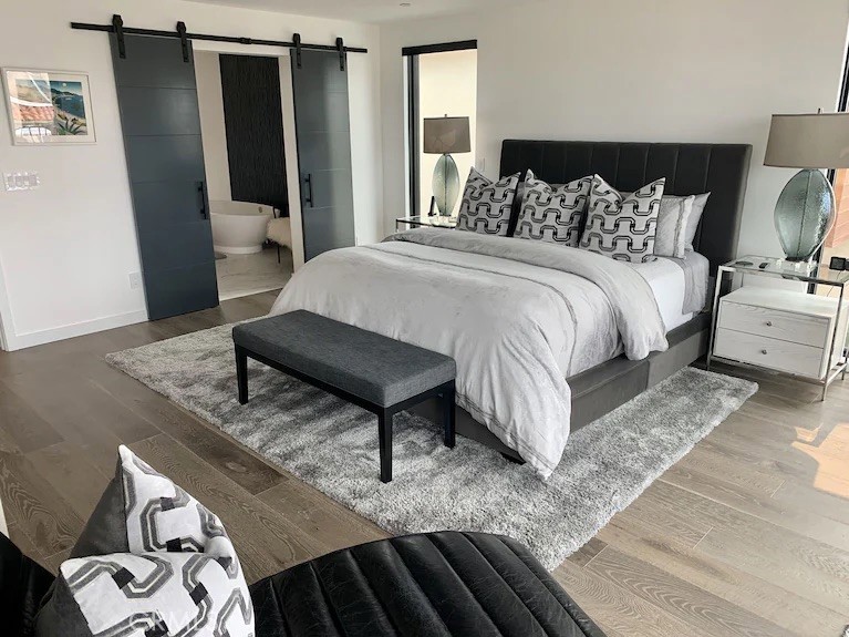 116 West Channel Islands Boulevard Oxnard, CA 93035 - Photo 28 of 60 a bedroom with a bed and wooden floor