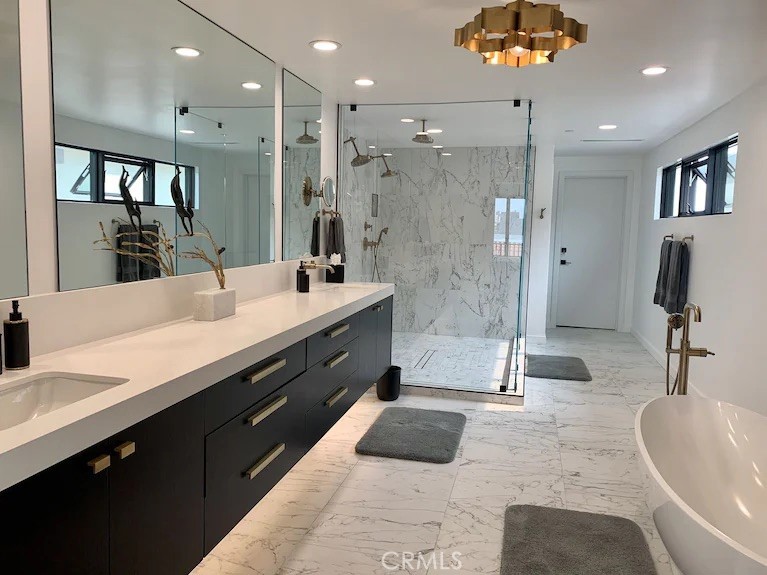 116 West Channel Islands Boulevard Oxnard, CA 93035 - Photo 29 of 60 a spacious bathroom with a double vanity sink a large mirror and a shower