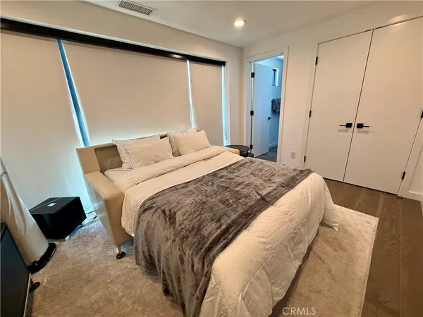 a room with a bed and a mirror