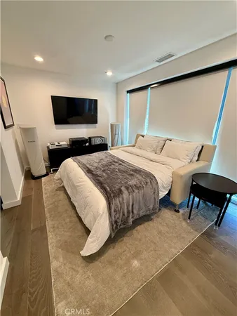 a bedroom with a bed and a rug