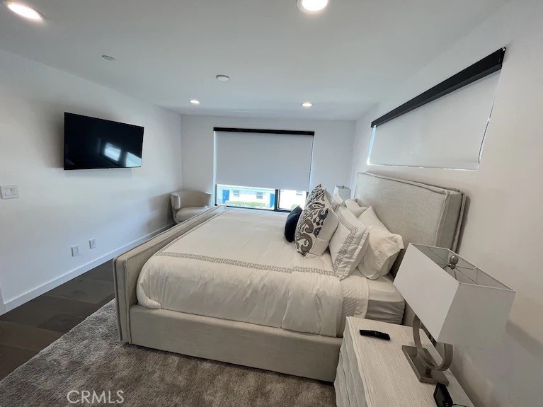 116 West Channel Islands Boulevard Oxnard, CA 93035 - Photo 38 of 60 a bedroom with a bed and a flat screen tv