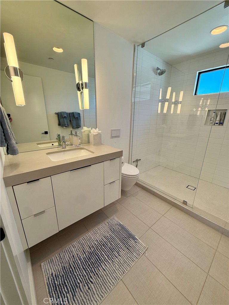 116 West Channel Islands Boulevard Oxnard, CA 93035 - Photo 42 of 60 a bathroom with a double vanity sink a toilet and a mirror