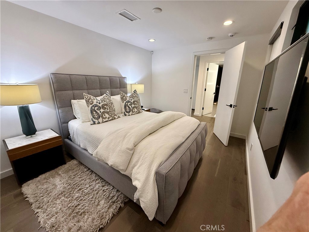 116 West Channel Islands Boulevard Oxnard, CA 93035 - Photo 44 of 60 a bedroom with a bed and a rug